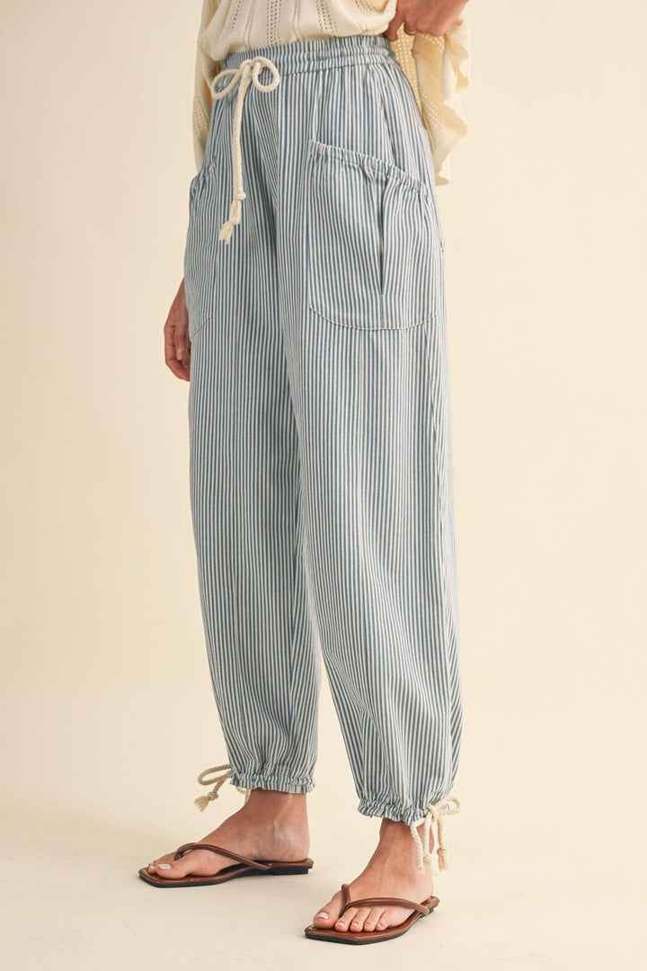 Close-up of denim stripe parachute pants — Heritage 1823 boutique.