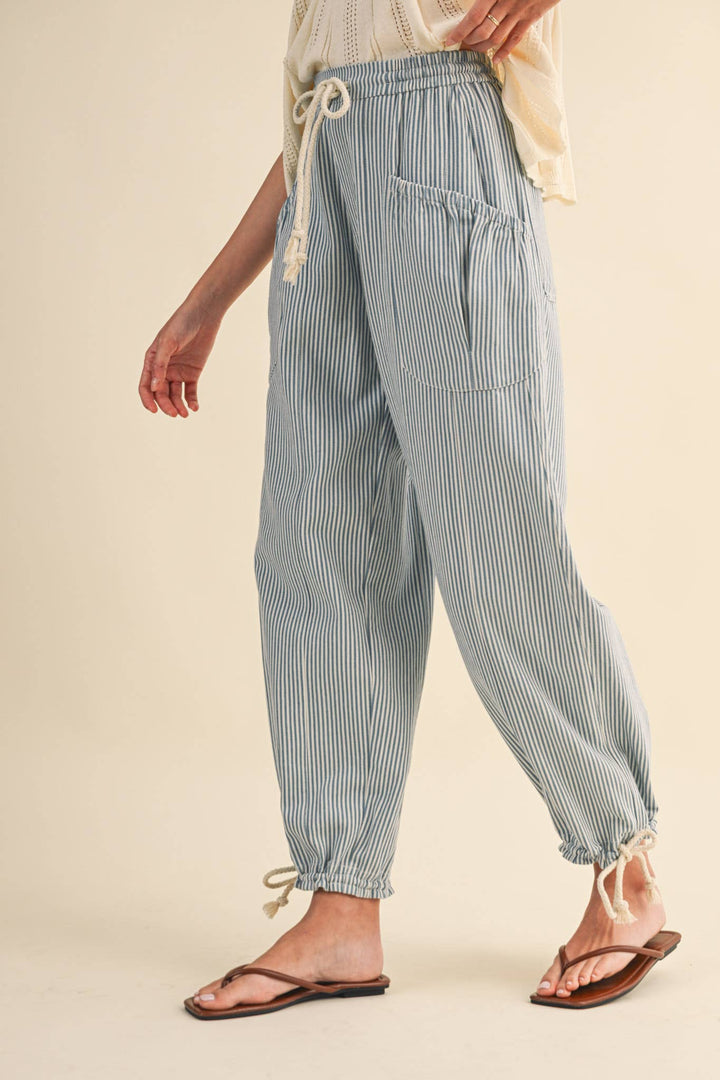 Close-up of denim stripe parachute pants — Heritage 1823 boutique.