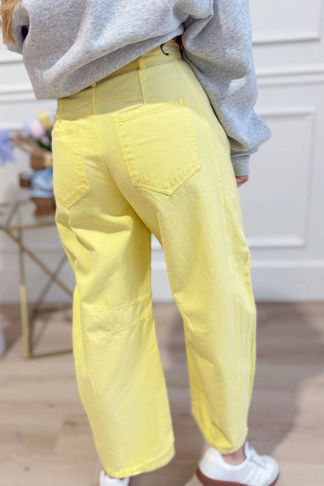 Model wearing yellow washed eyelet barrel pants — Heritage 1823 boutique.