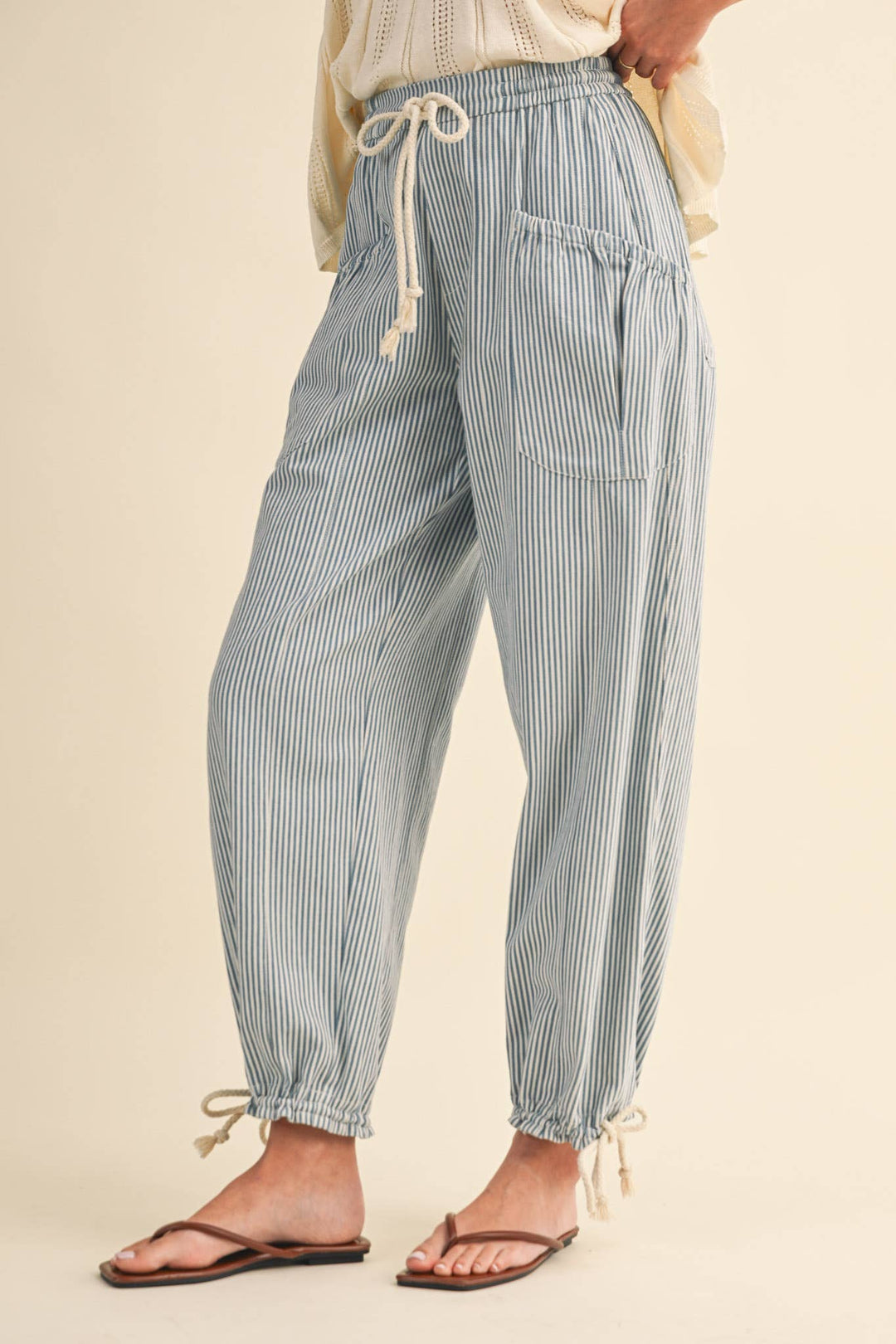 Close-up of denim stripe parachute pants — Heritage 1823 boutique.