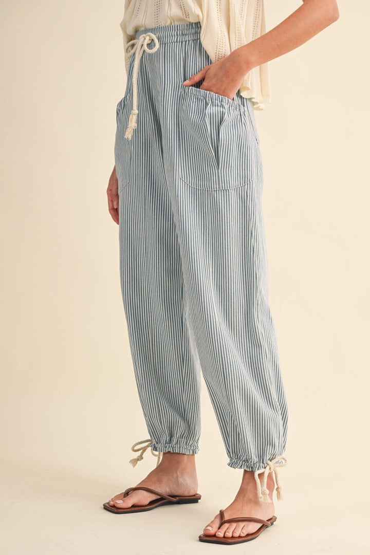 Detail view of denim stripe parachute pants — Heritage 1823 boutique.