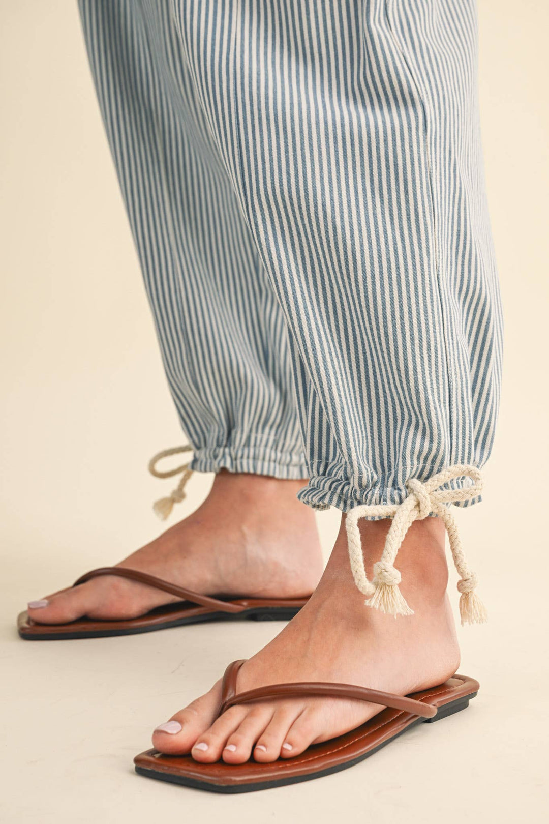 Close-up of denim stripe parachute pants — Heritage 1823 boutique.
