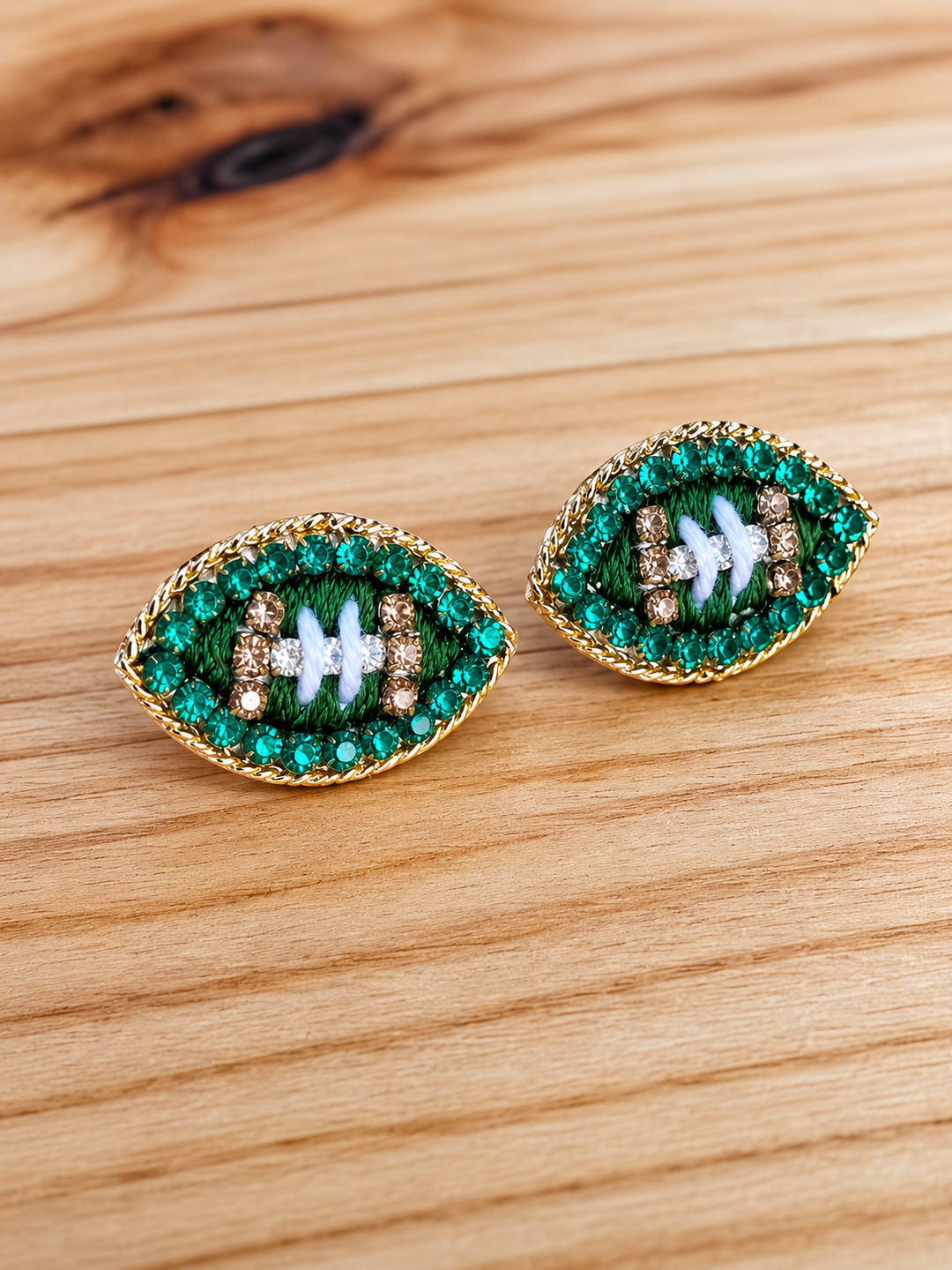 Green rhinestone football stud earrings — Heritage 1823, Dublin TX.