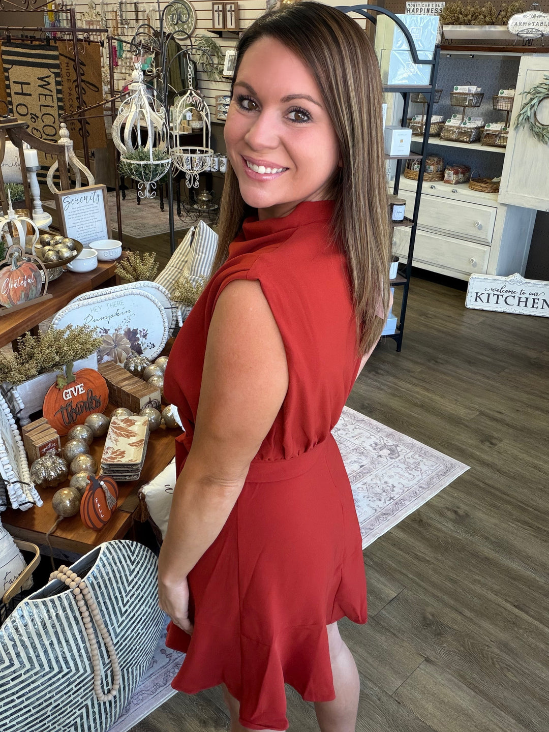 Back view of Autumn Allure Tie-Waist Mini Dress showing A-line skirt and ruffle hem in rust — Heritage 1823 Dublin, TX boutique.
