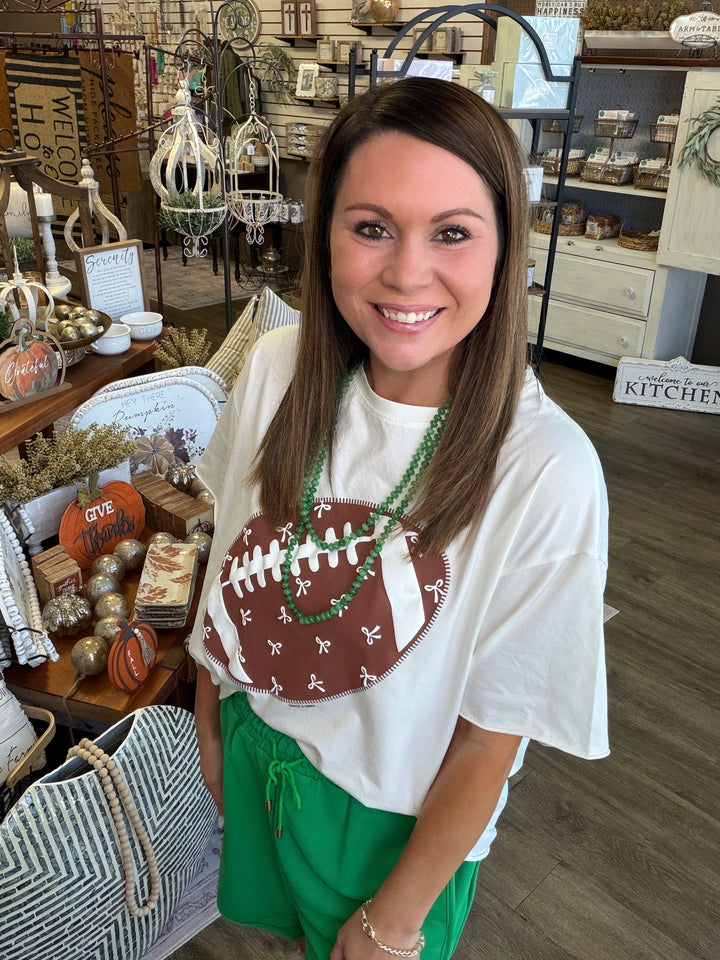 Model wearing Football Bow Boxy Graphic Tee — Heritage 1823 boutique.