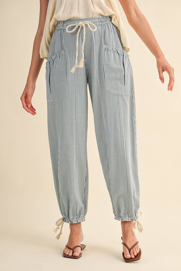 Front view of denim stripe parachute pants — Heritage 1823 boutique in Dublin, TX.