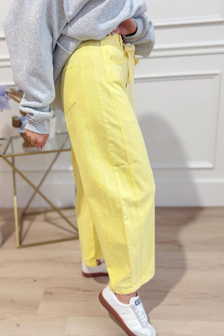 Side view of yellow washed eyelet barrel pants — Heritage 1823 boutique.