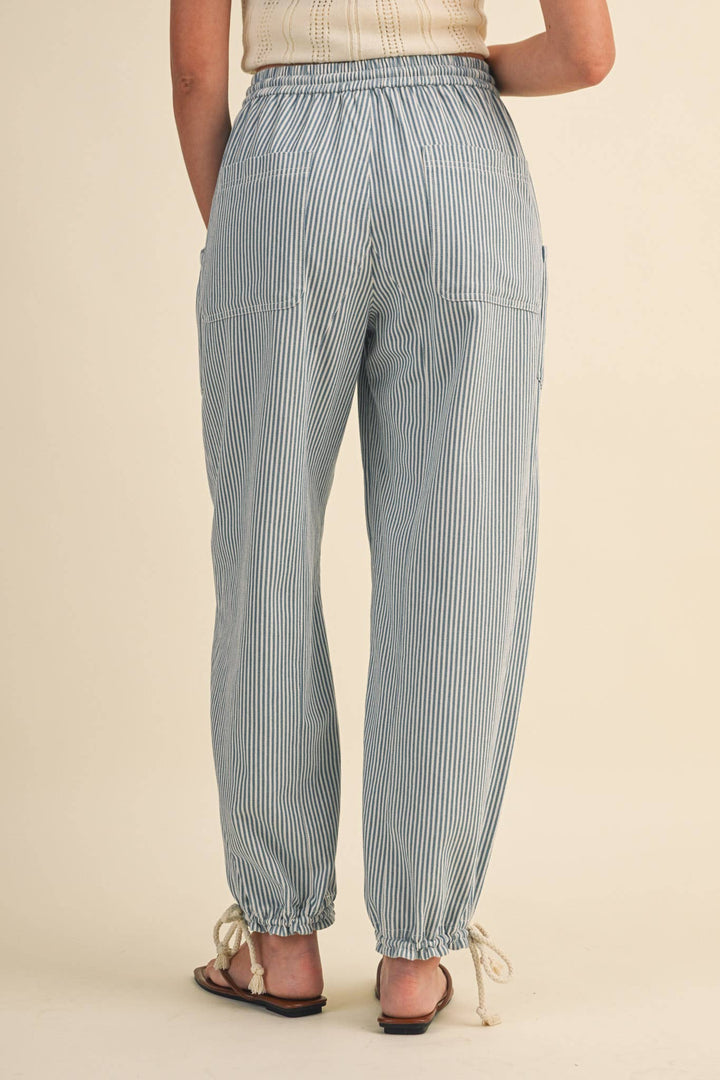Close-up of denim stripe parachute pants — Heritage 1823 boutique.